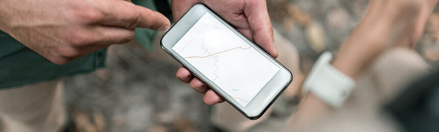 Hands Holding Phone with Map on Screen