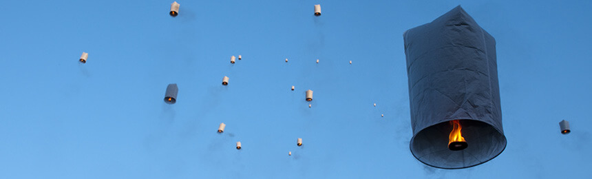 Paper Lanterns Floating in Blue Sky