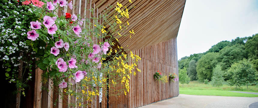 Green Acres Timber Building Exterior with Flowers