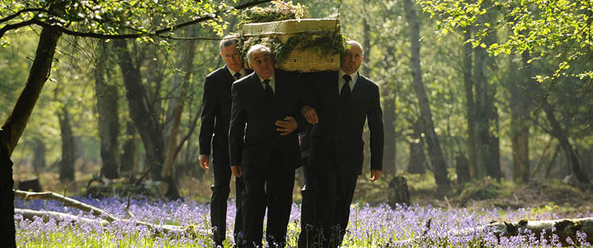 Pallbearers in Suits Carrying a Wooden Coffin in a Garden Green Acres Epping Forest Park