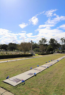 Image of the plaque unveiling ceremony at Lutwyche Cemetery, held by Cate Walker and Katrina Trevethan from the Australian Remembrance Army, in association with the Toowong RSL Sub-Branch.